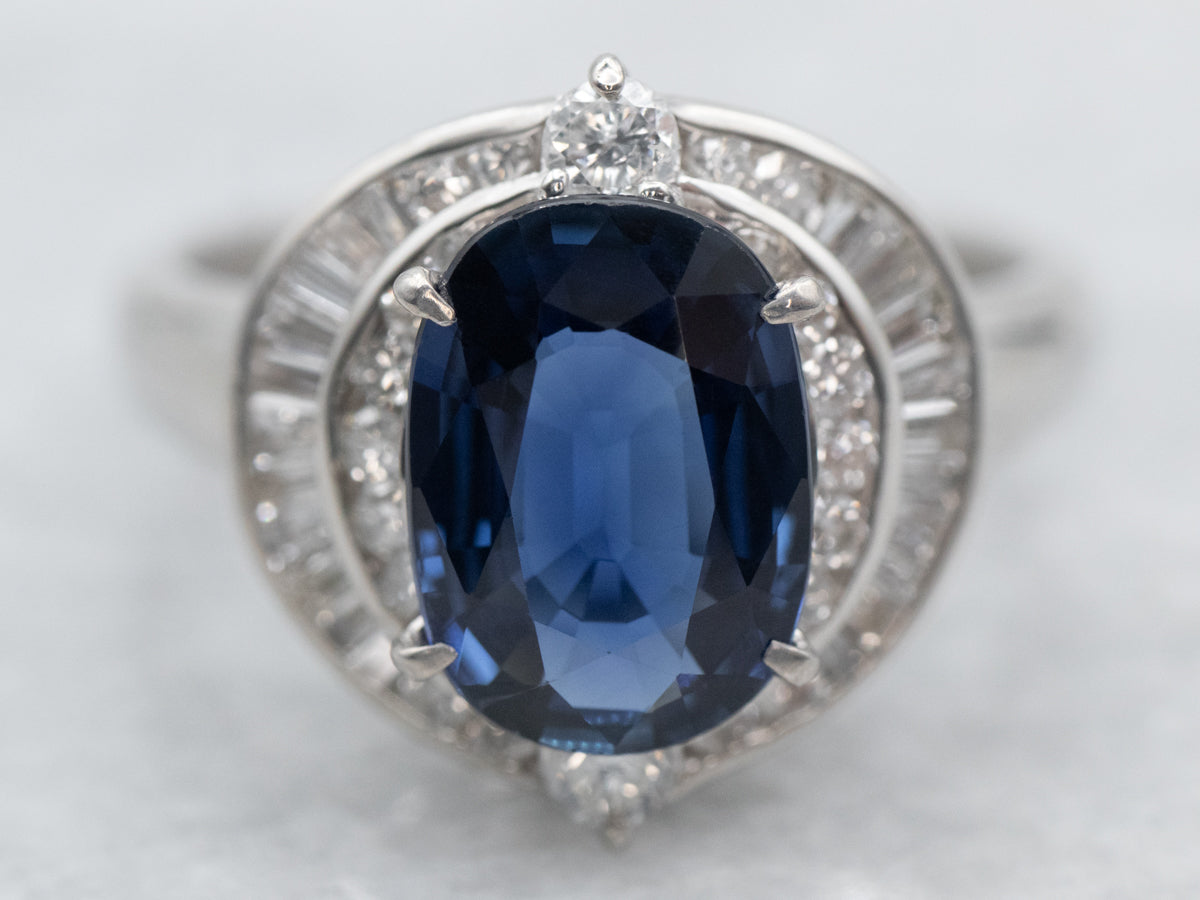 Platinum Oval Cut Sapphire Engagement Ring with Round and Baguette Cut Diamond Halo