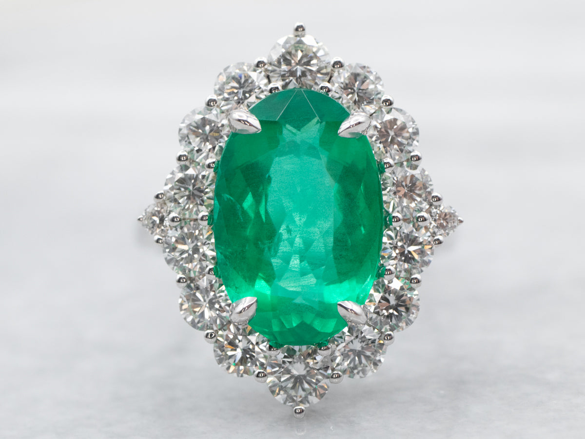 White Gold Oval Cut Emerald Ring with Diamond Halo