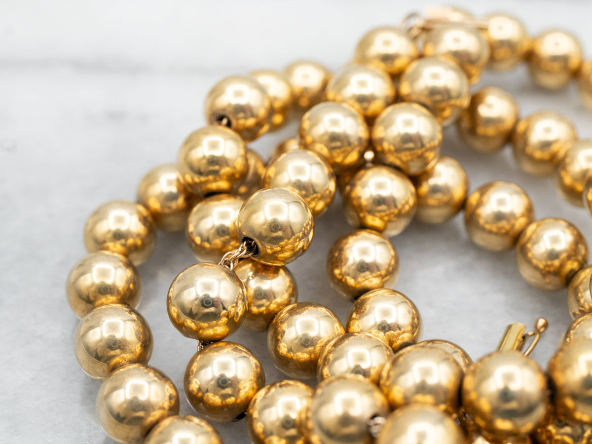 Polished Gold Beaded Necklace with Barrel Clasp