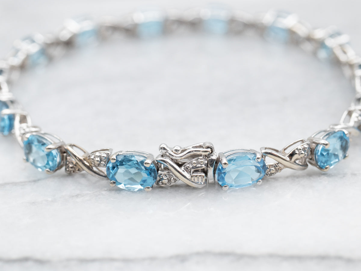 White Gold Blue Topaz X Link Tennis Bracelet with Diamond Accents