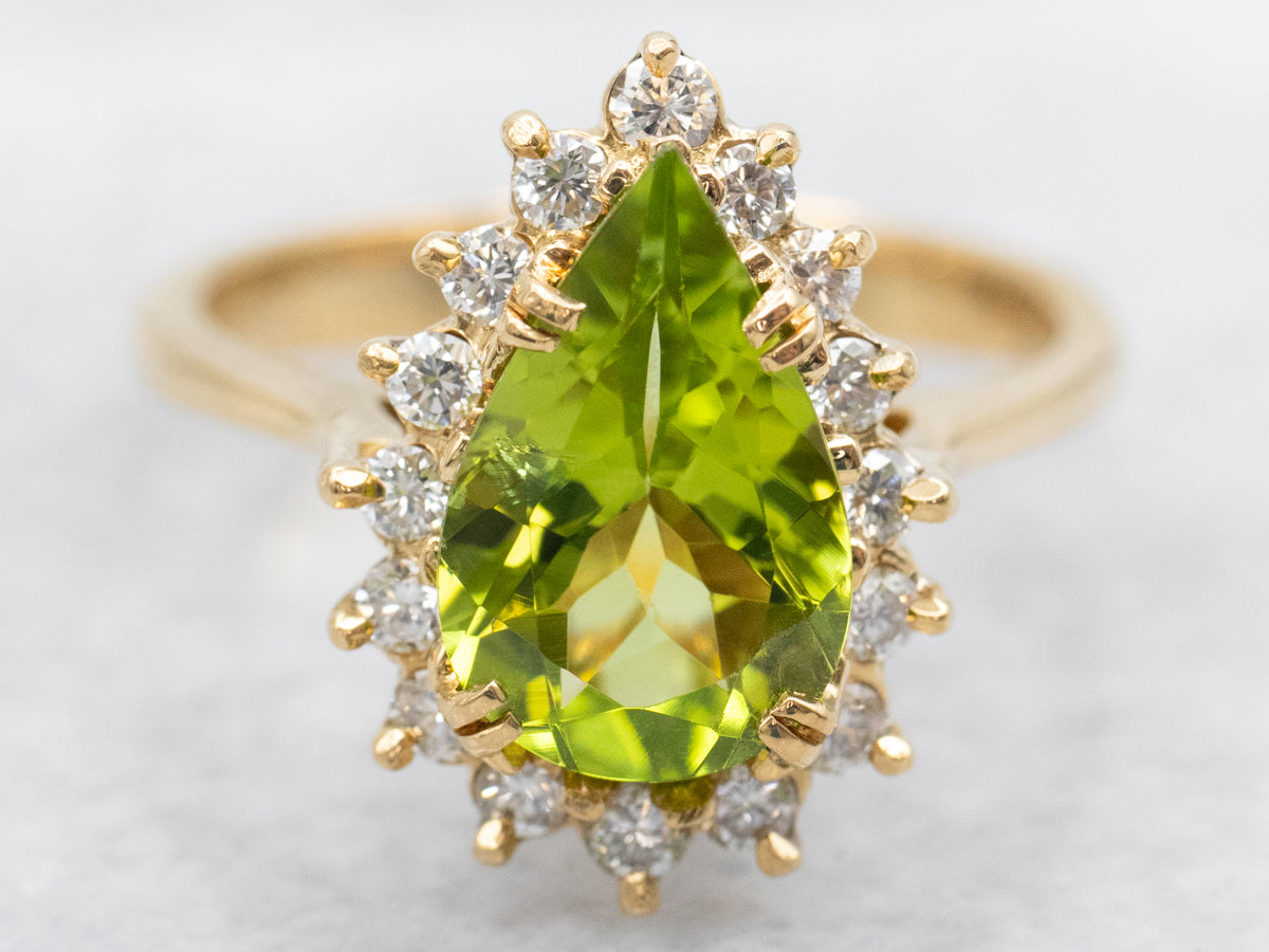 Anillo de oro amarillo con peridoto y halo de diamantes