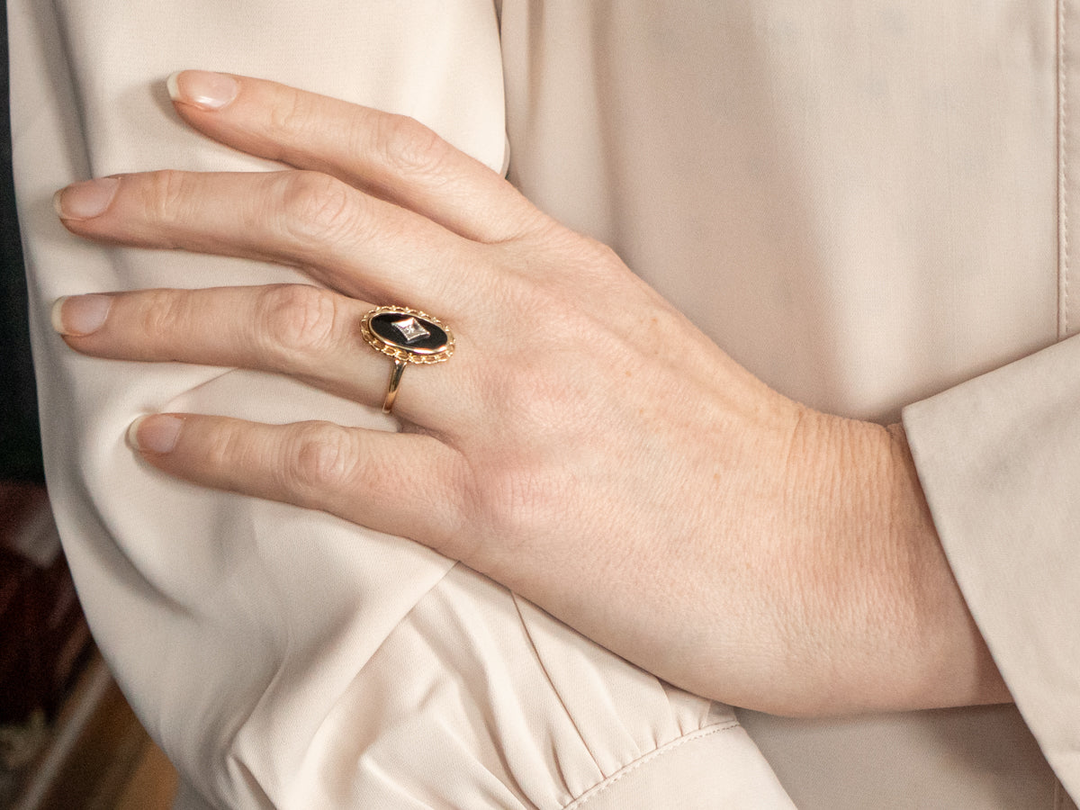 Woman’s newest onyx ring with diamonds in center.