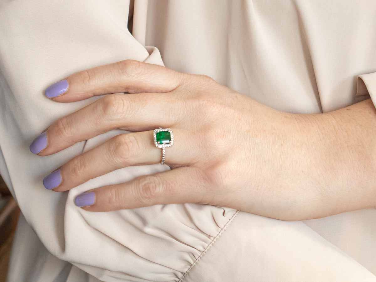 Modern Emerald and Diamond Halo Engagement Ring