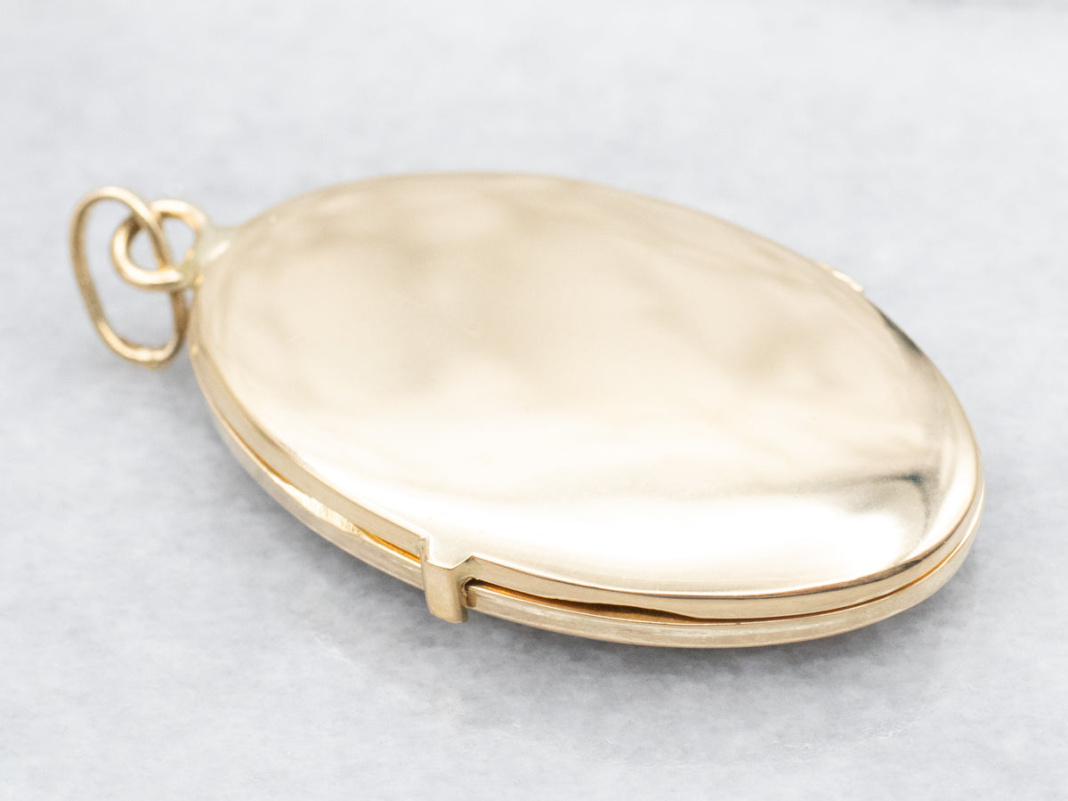 Oval 18-Kart Gold Locket with Scrolling Botanical Design