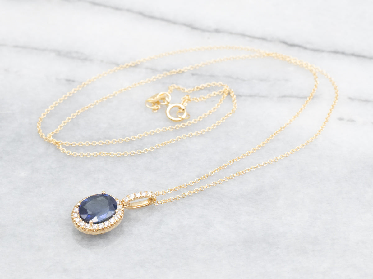 Modern Gold Sapphire Halo Pendant on Cable Chain