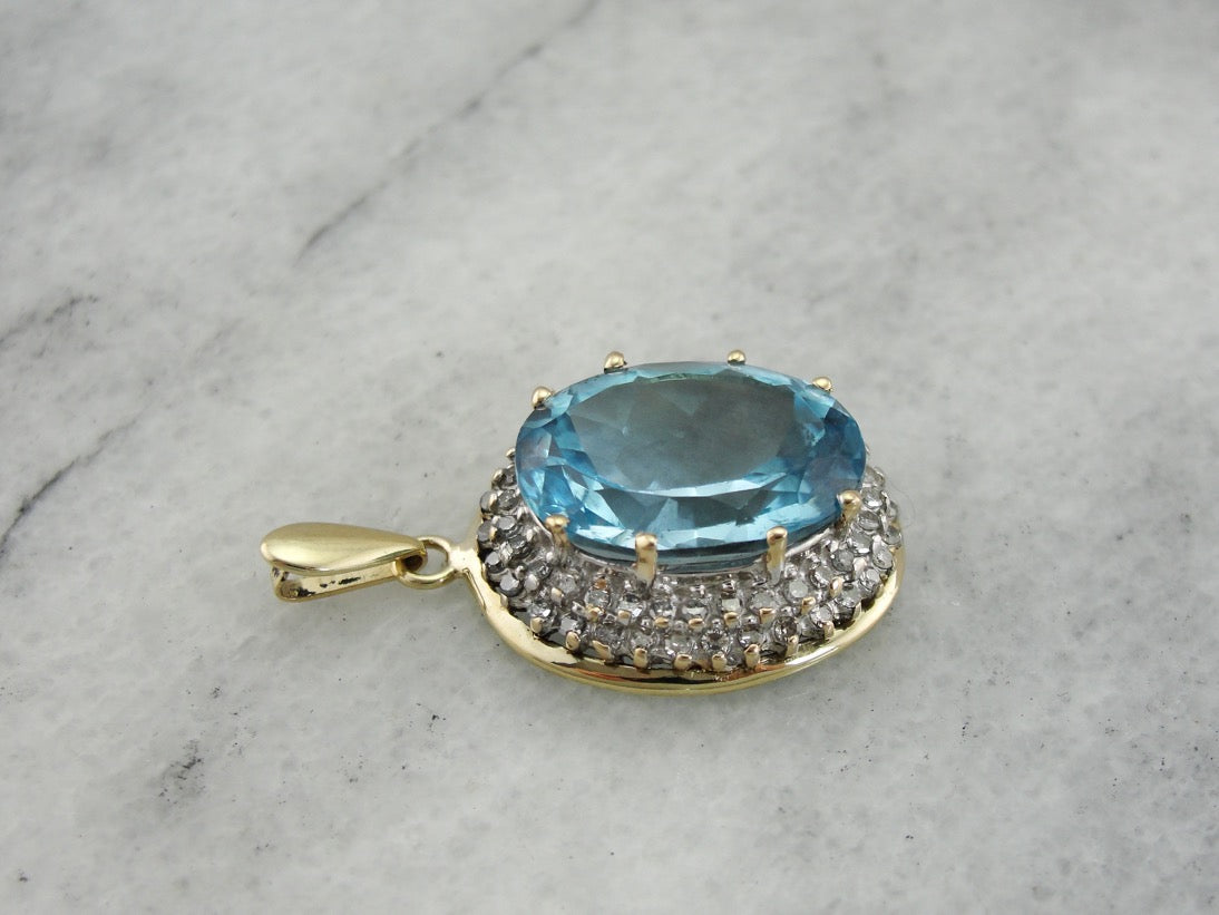 Stunning Blue Topaz Pendant with Diamond Halo in Two Tone Gold