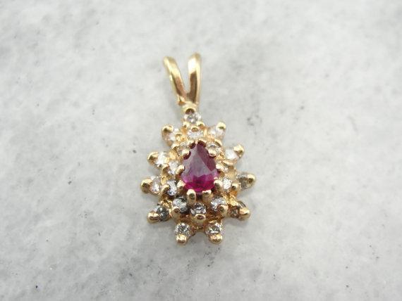 Ruby and Diamond Halo Pendant in Yellow Gold