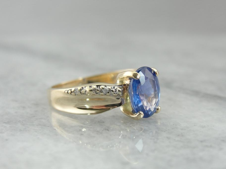 Twisting and Elegant Sapphire Ring with Diamond Accents